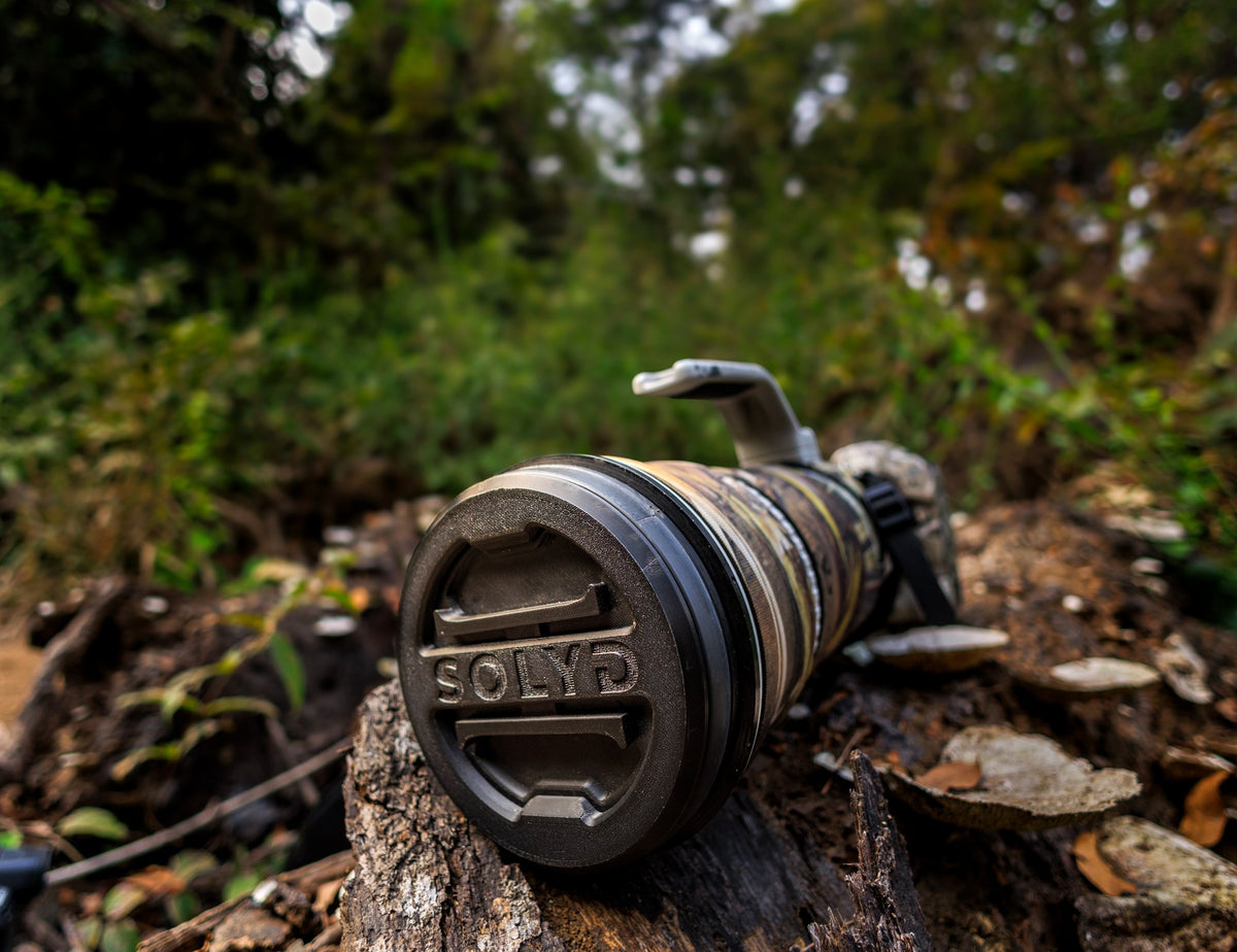 SOLYD lens cap fitted on a super-telephoto lens in the forest